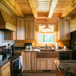 Log Home Kitchen with Copper Farmhouse Sink