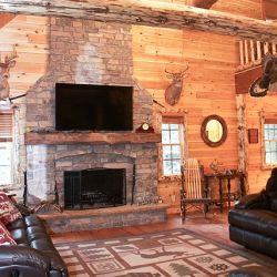 Rustic Log Home with Stone Covered Fire Place 
